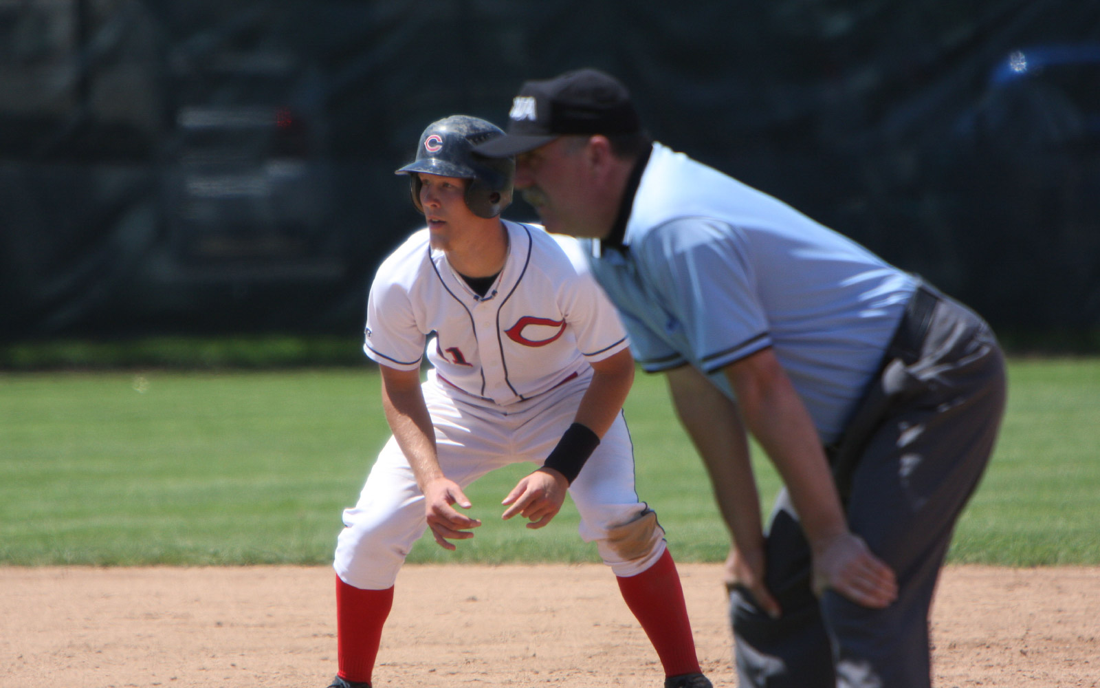 A baseball player about to steal a base A baseball player about to steal a base