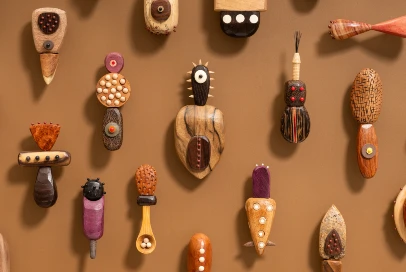 Wooden sculptural textured objects displayed on a wall