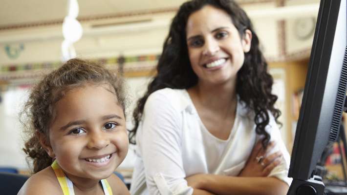 A student smiling with a teacher