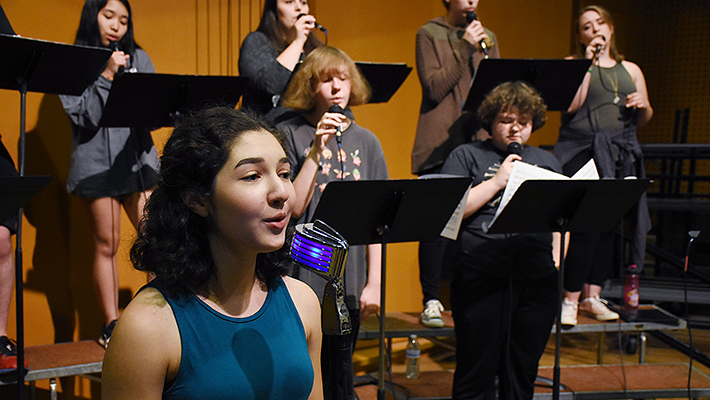 performers sing at CCC