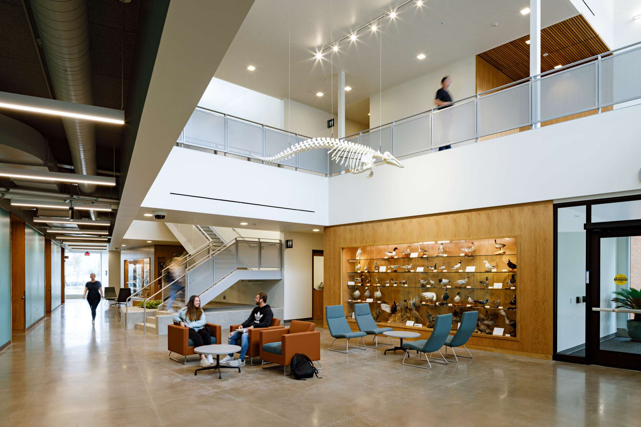 The main lounge of DeJardin Hall, with studying chairs and students The main lounge of DeJardin Hall, with studying chairs and students
