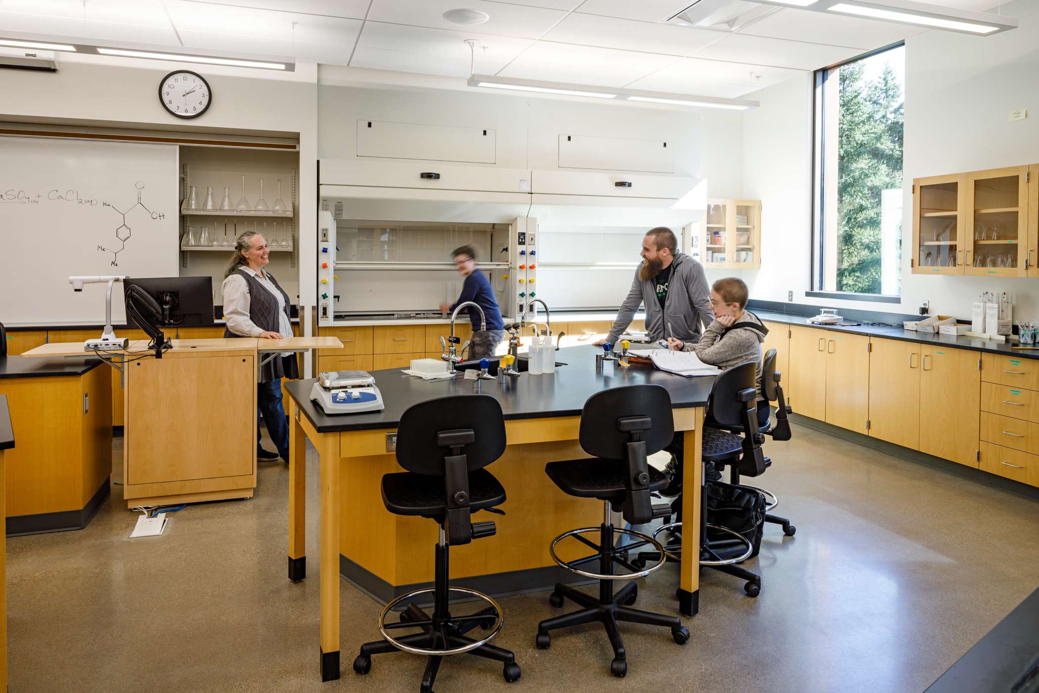 A chemistry lab with students and teachers working together A chemistry lab with students and teachers working together