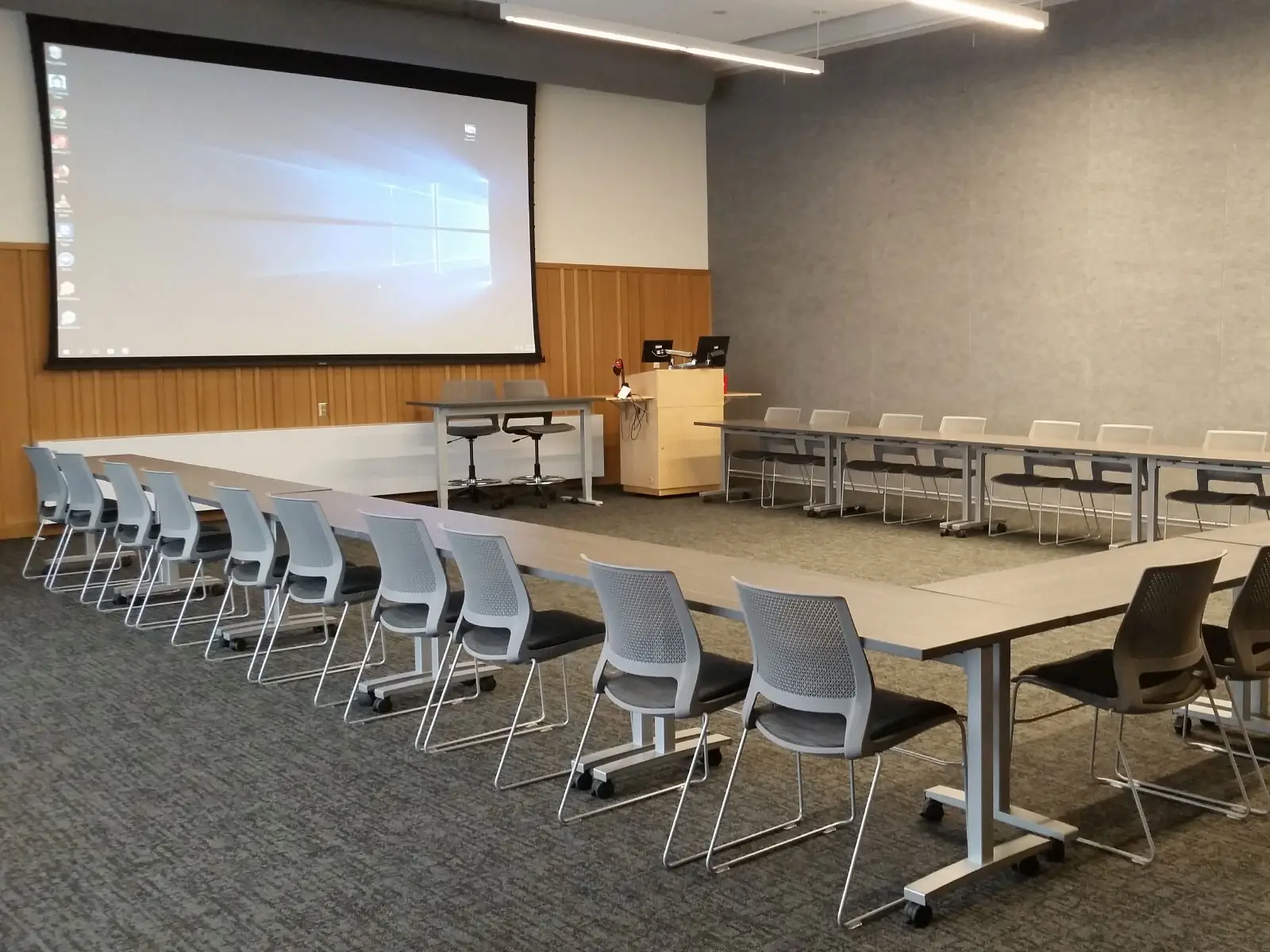 Square-shaped rows of chairs and tables in Harmony Campus community room