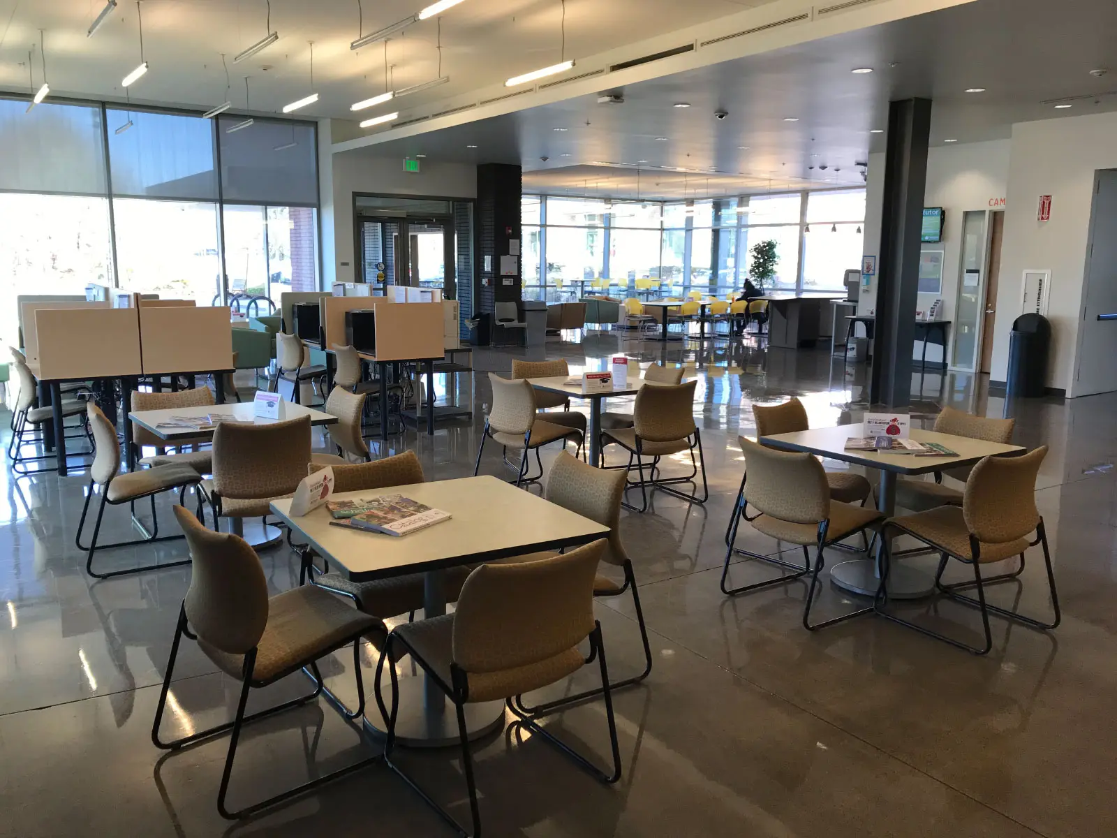 Series of chairs and small tables in Harmony Campus lobby