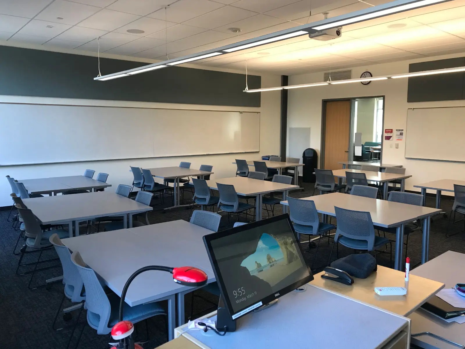 Several tables with chairs in front of a podium in a Oregon City campus classroom