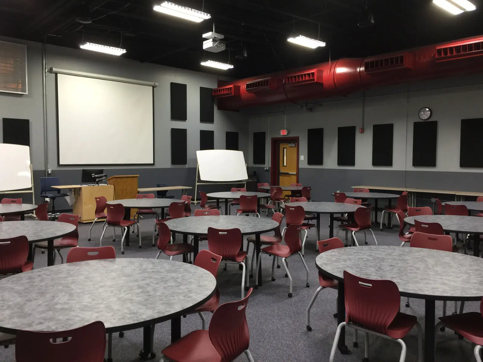 Many tables and chairs in front of a projector display in classroom W108B on the WIlsonville campus Many tables and chairs in front of a projector display in classroom W108B on the WIlsonville campus