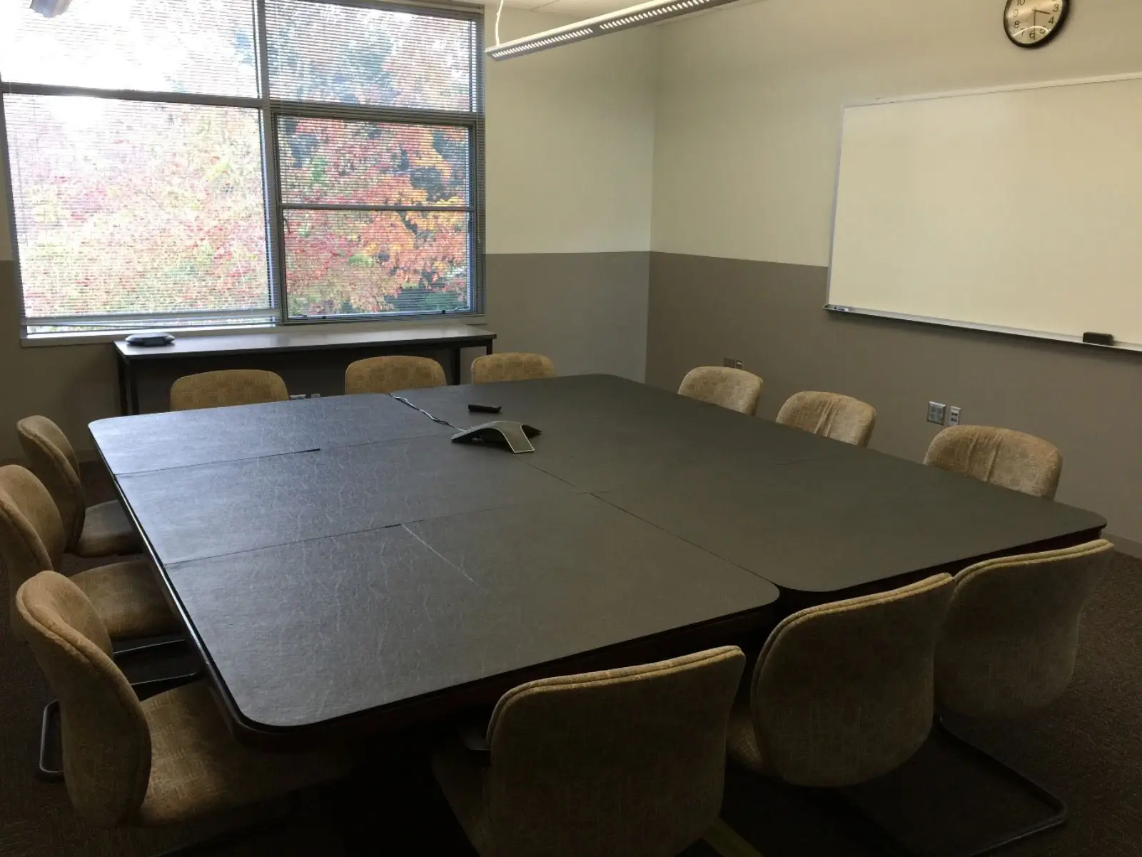 Conference room with 12 chairs and a table with center phone, white board on the wall and window in classroom W207 on the Wilsonville campus Conference room with 12 chairs and a table with center phone, white board on the wall and window in classroom W207 on the Wilsonville campus