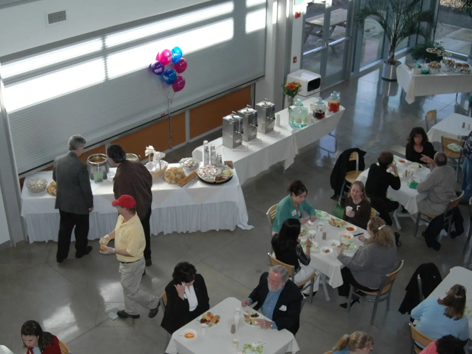 Overhead view of a catered event with various foods and drinks at the Wilsonville campus in the commons Overhead view of a catered event with various foods and drinks at the Wilsonville campus in the commons