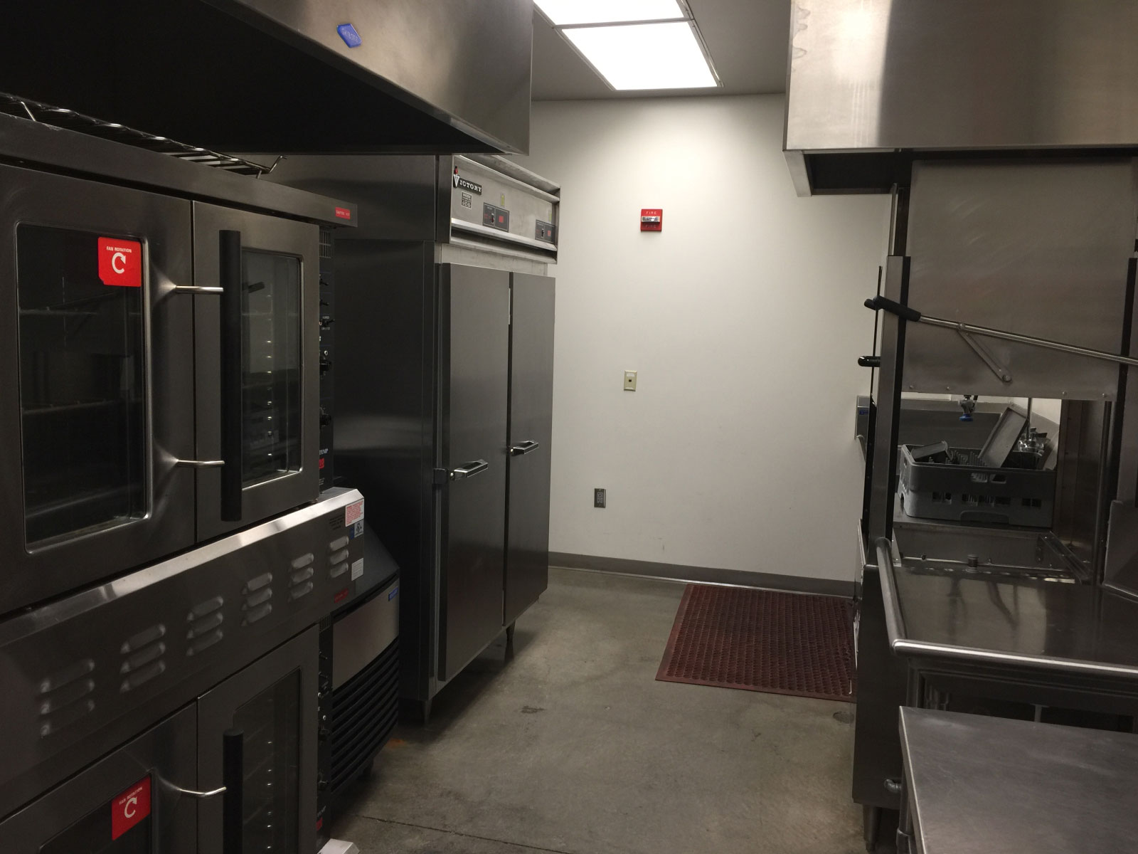 The back area of the Wilsonville campus kitchen area with a refridgerator, dishwasher and heating units The back area of the Wilsonville campus kitchen area with a refridgerator, dishwasher and heating units