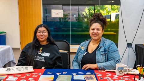 Two CCC staff members at a resources table