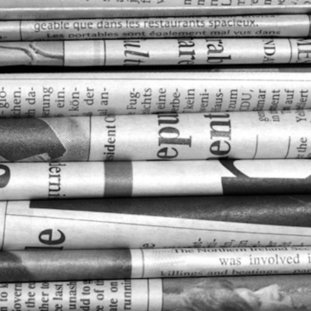 A stack of folded newspapers