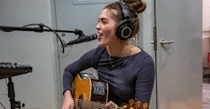 Woman singing and playing guitar
