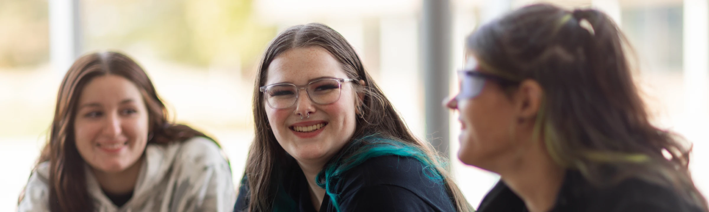 Three smiling CCC students