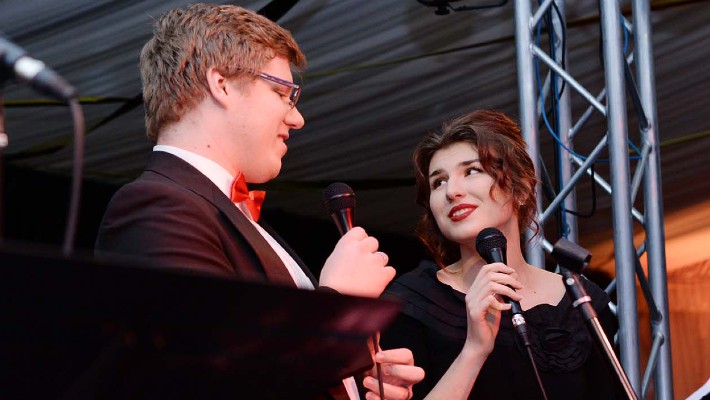 Two students singing a duet on stage