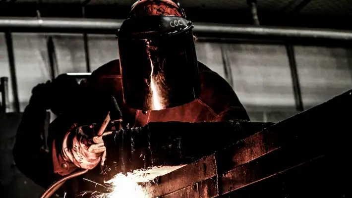 Welder in a dark workshop