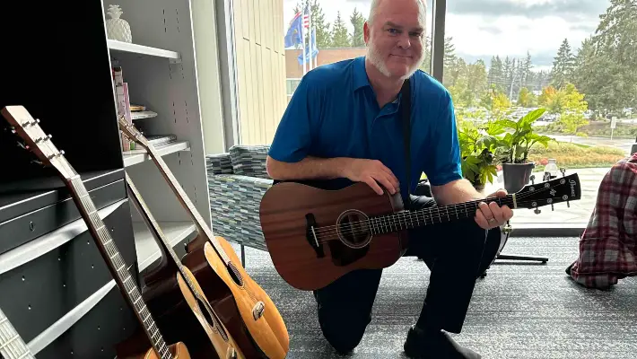 CCC counselor posing with guitars. This photo by Gabriel Lucich won first place at the 2024 ONPA Collegiate Newspaper Contest.