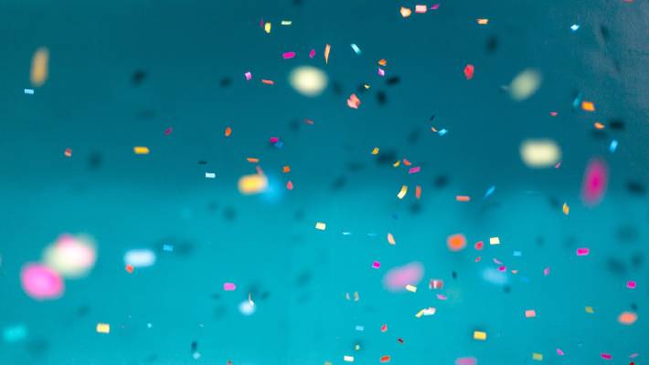 Confetti against a teal background